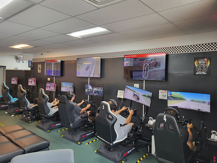 Racers driving in professional sim racing center